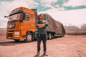 man looking at the horizon with a truck in the background